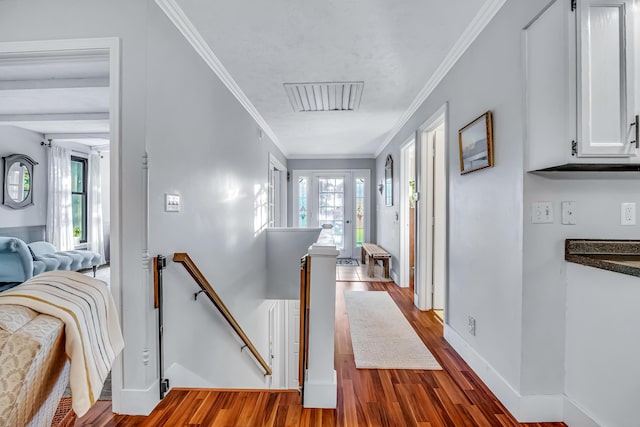 9180 Dicey St, Montague, MI 49437 - hallway with an upstairs landing, wood finished floors, crown molding, and baseboards