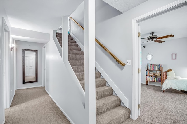 9180 Dicey St, Montague, MI 49437 - stairway featuring carpet flooring, a ceiling fan, and baseboards