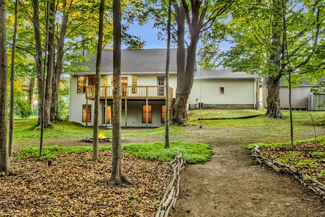 9180 Dicey St, Montague, MI 49437 - back of house with a wooden deck, a yard, and roof with shingles