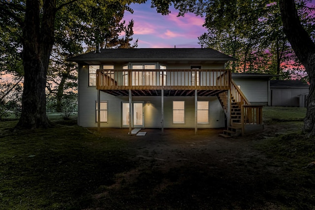 9180 Dicey St, Montague, MI 49437 - back of house at dusk featuring a deck and stairs