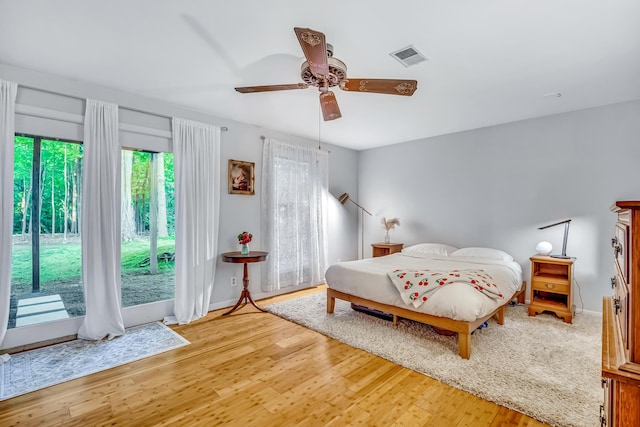 9180 Dicey St, Montague, MI 49437 - bedroom featuring access to outside, light wood-style flooring, a ceiling fan, and baseboards