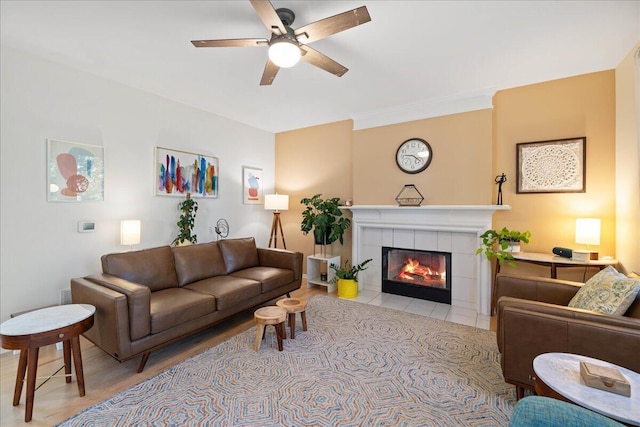 1269 Apple Creek Dr SE, Grand Rapids, MI 49546 - living area with a ceiling fan, a tiled fireplace, and wood finished floors