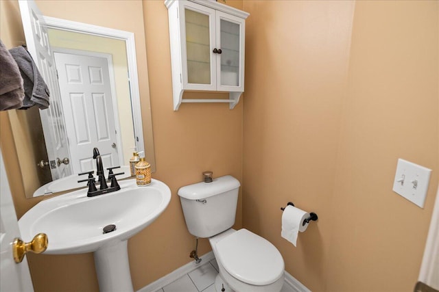 1269 Apple Creek Dr SE, Grand Rapids, MI 49546 - half bathroom featuring toilet, tile patterned floors, baseboards, and a sink
