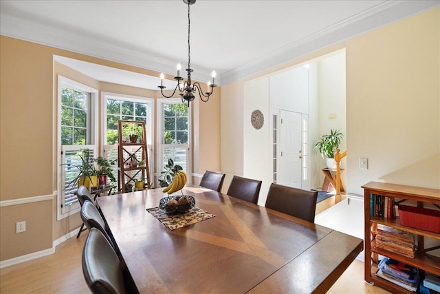 1269 Apple Creek Dr SE, Grand Rapids, MI 49546 - dining room with a chandelier, ornamental molding, baseboards, and light wood-type flooring