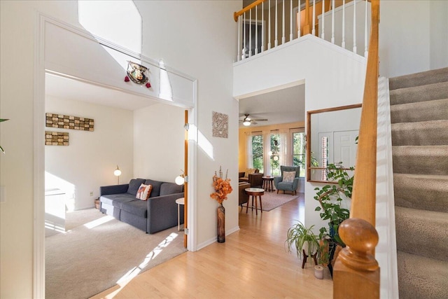 1269 Apple Creek Dr SE, Grand Rapids, MI 49546 - entryway with stairway, wood finished floors, a ceiling fan, a high ceiling, and baseboards