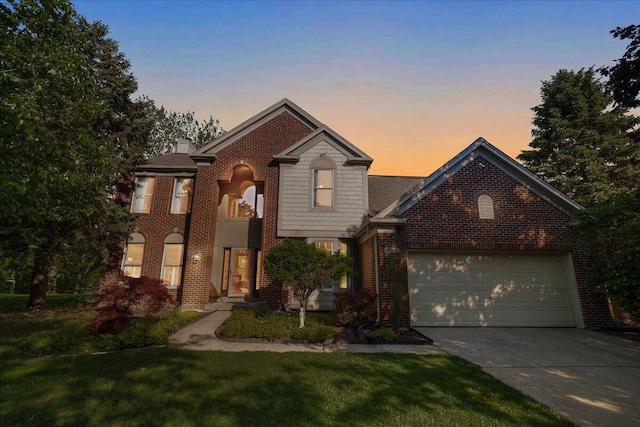 1269 Apple Creek Dr SE, Grand Rapids, MI 49546 - view of front of property with concrete driveway, a yard, brick siding, an attached garage, and a chimney