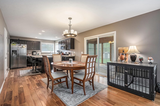 69218 Sundance Dr, Edwardsburg, MI 49112 - dining space with a chandelier, light wood-type flooring, and recessed lighting