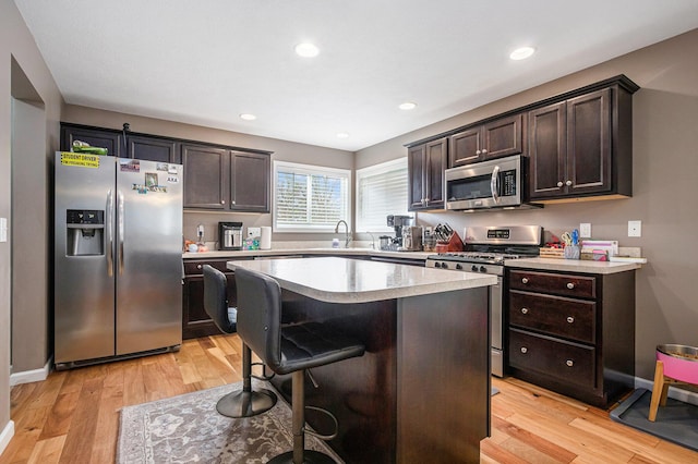 69218 Sundance Dr, Edwardsburg, MI 49112 - kitchen featuring appliances with stainless steel finishes, dark brown cabinets, a sink, and recessed lighting
