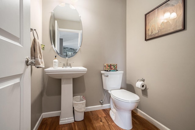 69218 Sundance Dr, Edwardsburg, MI 49112 - bathroom with wood finished floors, toilet, and baseboards