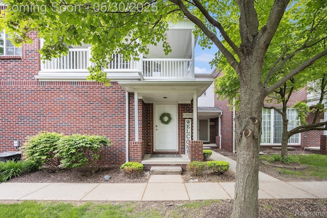 6769 Boulder Pointe Dr, Washington, MI 48094 - view of front facade featuring a balcony and brick siding