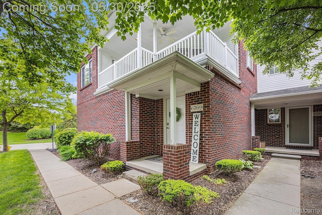6769 Boulder Pointe Dr, Washington, MI 48094 - doorway to property with brick siding, a balcony, and a ceiling fan