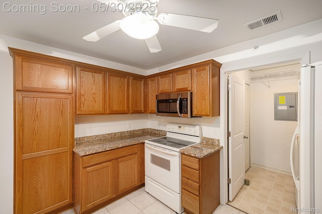 6769 Boulder Pointe Dr, Washington, MI 48094 - kitchen with white appliances, electric panel, stone countertops, brown cabinets, and ceiling fan