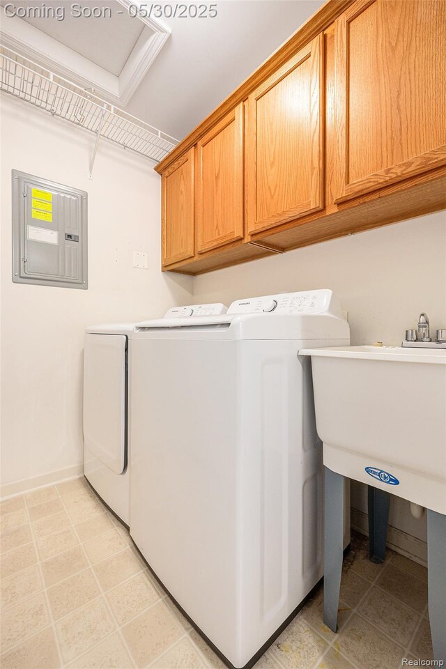 6769 Boulder Pointe Dr, Washington, MI 48094 - washroom featuring electric panel, washing machine and clothes dryer, cabinet space, and baseboards