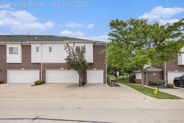 6769 Boulder Pointe Dr, Washington, MI 48094 - view of front of home with concrete driveway, brick siding, and a garage