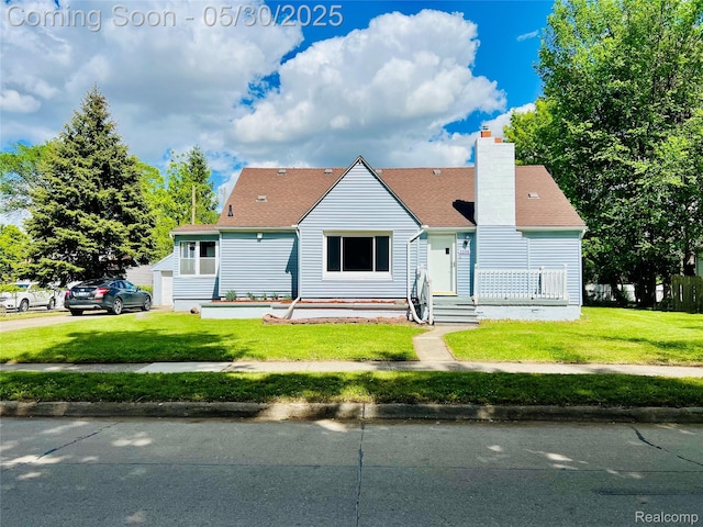 22380 Panama Ave, Sterling Heights, MI 48091 - view of front of home with a front lawn, a chimney, and roof with shingles