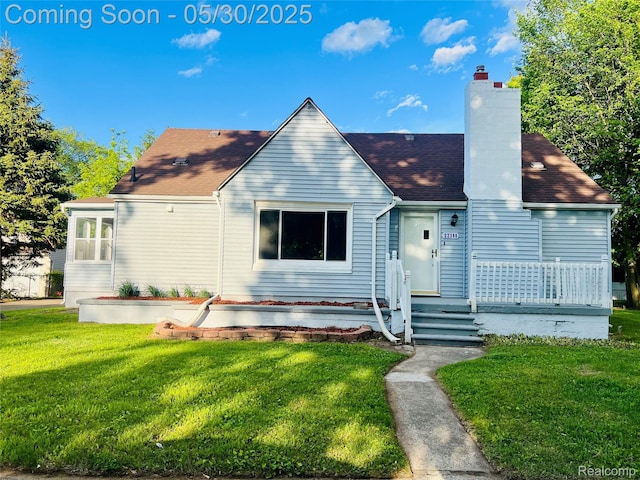 22380 Panama Ave, Sterling Heights, MI 48091 - view of front of home with a front lawn, a chimney, and roof with shingles