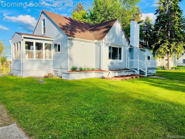 22380 Panama Ave, Sterling Heights, MI 48091 - view of property exterior featuring a chimney, a sunroom, and a lawn