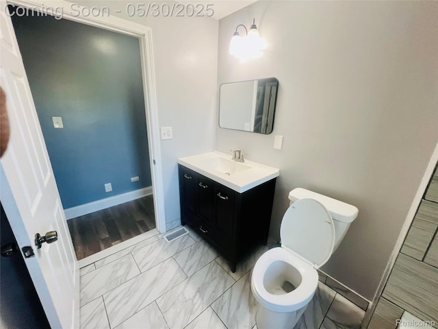 22380 Panama Ave, Sterling Heights, MI 48091 - bathroom with vanity, toilet, and baseboards