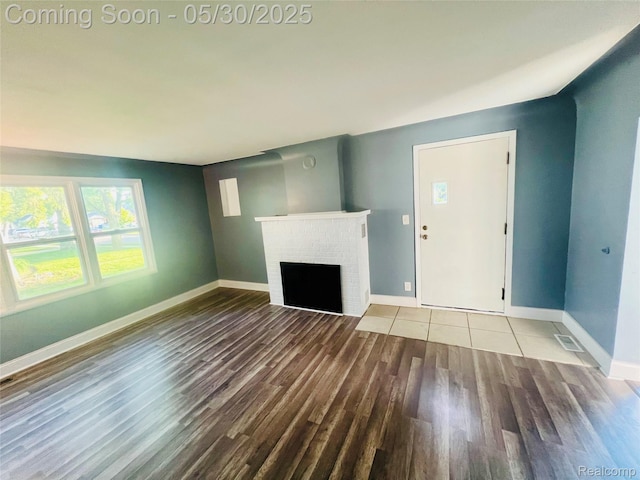 22380 Panama Ave, Sterling Heights, MI 48091 - unfurnished living room featuring wood finished floors, a fireplace, and baseboards