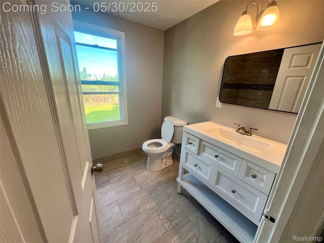 22380 Panama Ave, Sterling Heights, MI 48091 - bathroom with toilet, vanity, and baseboards