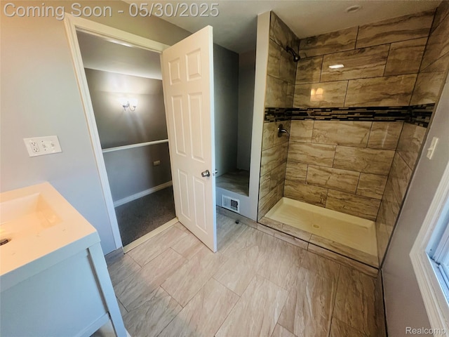22380 Panama Ave, Sterling Heights, MI 48091 - full bath with a tile shower, vanity, and baseboards