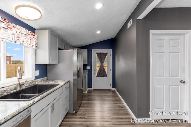 11943 Mulliken Rd, Mulliken, MI 48861 - kitchen with appliances with stainless steel finishes, a sink, a textured ceiling, dark wood-style flooring, and light countertops