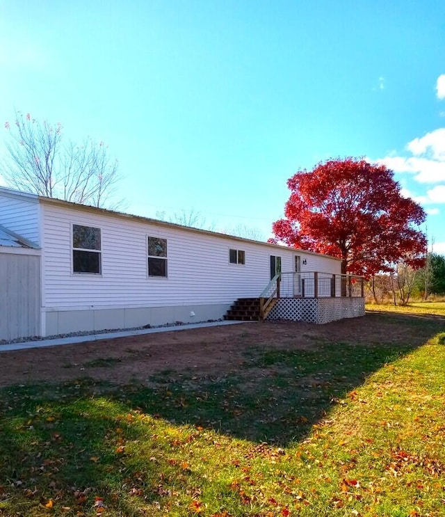 6334 N 168th Ave, Walkerville, MI 49459 - back of property with a deck and a lawn