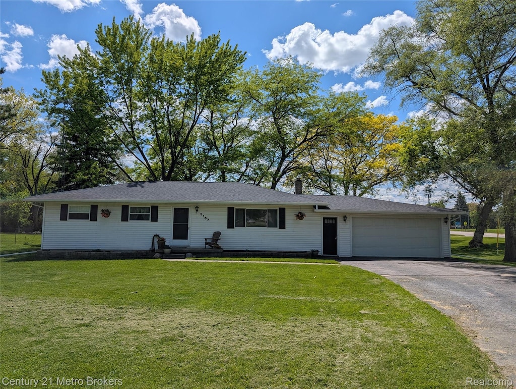 3167 Dot Ave, Flint, MI 48506 - single story home with asphalt driveway, a garage, a front lawn, and a chimney