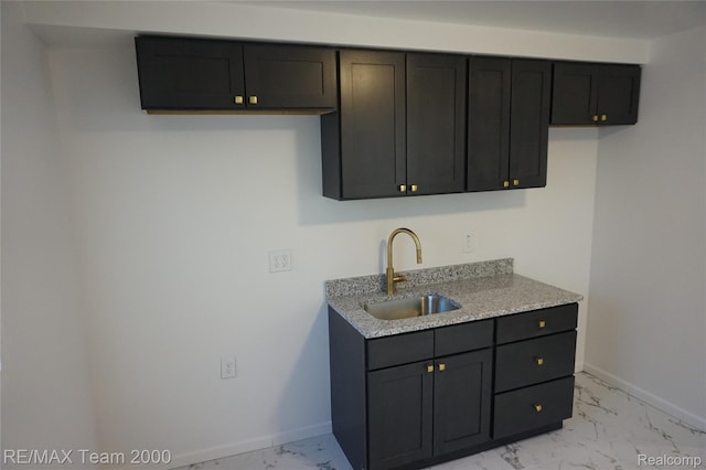 26017 Stanford St, Inkster, MI 48141 - kitchen with a sink, light marble finish flooring, baseboards, and light stone counters