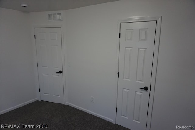 26017 Stanford St, Inkster, MI 48141 - unfurnished room with dark colored carpet, a smoke detector, and baseboards