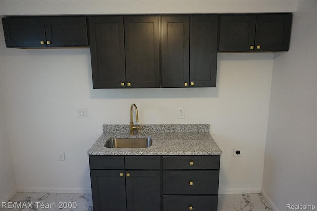 26017 Stanford St, Inkster, MI 48141 - kitchen with a sink, light marble finish flooring, baseboards, and light stone counters