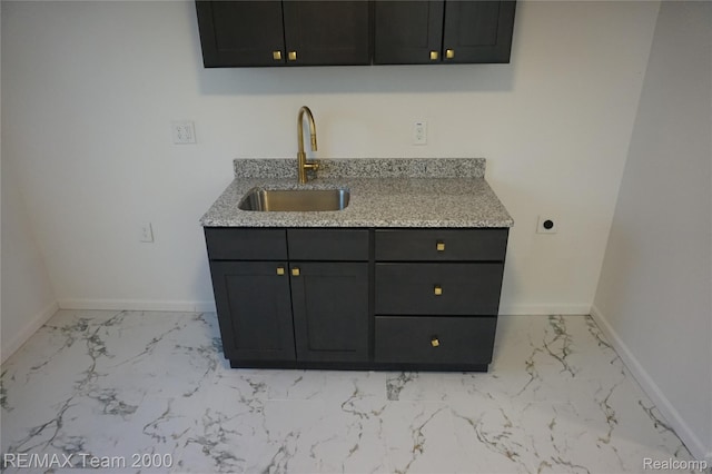 26017 Stanford St, Inkster, MI 48141 - kitchen with a sink, light marble finish flooring, baseboards, and light stone countertops