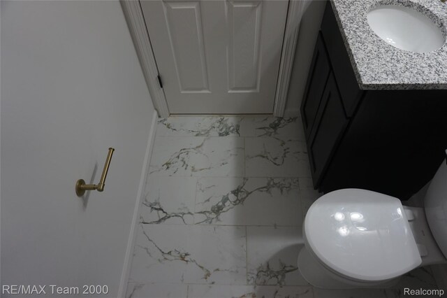 26017 Stanford St, Inkster, MI 48141 - bathroom with marble finish floors, vanity, and toilet