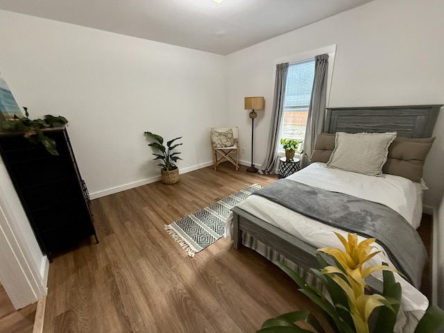 1581 W Lone Pine Dr, Baldwin, MI 49304 - bedroom featuring wood finished floors and baseboards