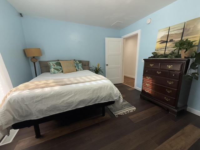 1581 W Lone Pine Dr, Baldwin, MI 49304 - bedroom with dark wood-style flooring and baseboards