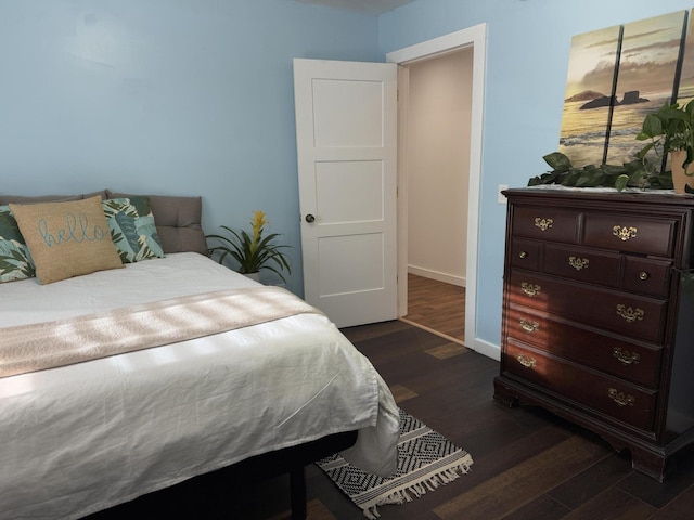 1581 W Lone Pine Dr, Baldwin, MI 49304 - bedroom with dark wood-style flooring and baseboards