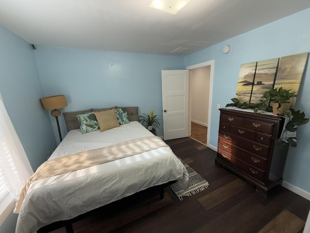 1581 W Lone Pine Dr, Baldwin, MI 49304 - bedroom with dark wood-style flooring and baseboards