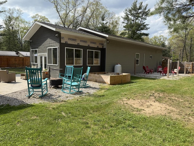 1581 W Lone Pine Dr, Baldwin, MI 49304 - rear view of house with a fire pit and a patio