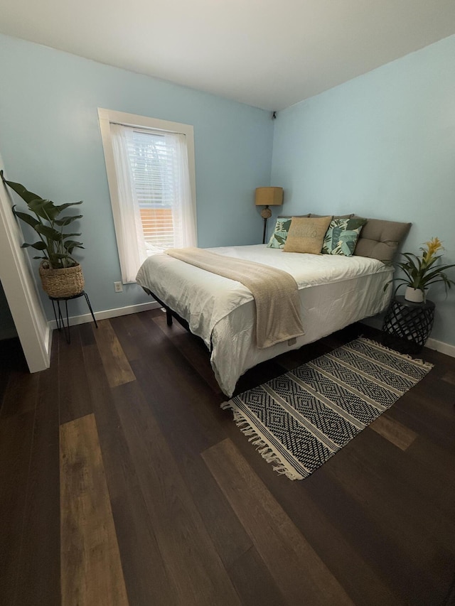 1581 W Lone Pine Dr, Baldwin, MI 49304 - bedroom with dark wood-style floors and baseboards