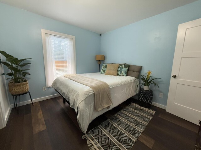 1581 W Lone Pine Dr, Baldwin, MI 49304 - bedroom featuring dark wood-type flooring and baseboards