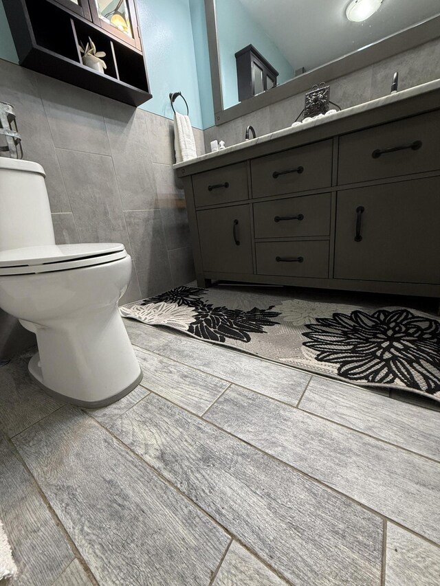 1581 W Lone Pine Dr, Baldwin, MI 49304 - bathroom with tile walls, toilet, and vanity