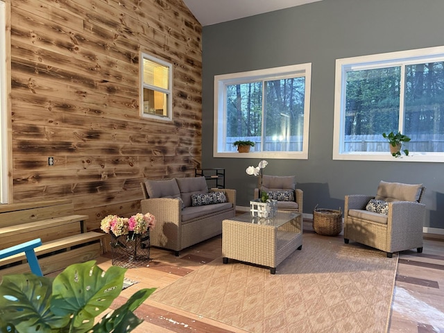 1581 W Lone Pine Dr, Baldwin, MI 49304 - living room featuring healthy amount of natural light, wood finished floors, lofted ceiling, and wood walls