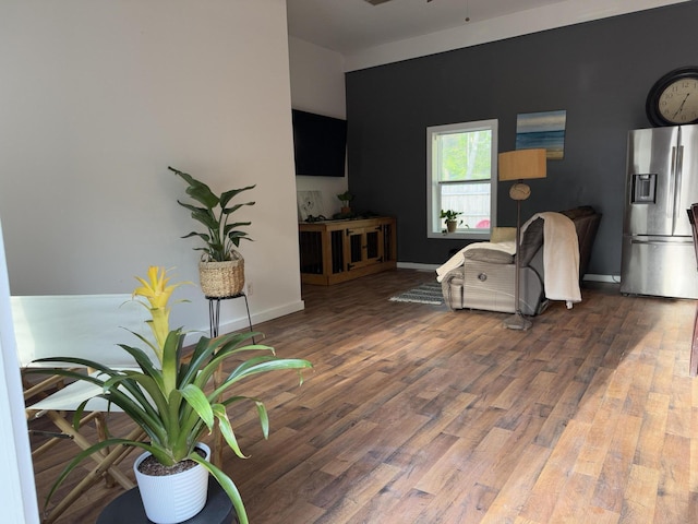 1581 W Lone Pine Dr, Baldwin, MI 49304 - living area with wood finished floors, a ceiling fan, and baseboards