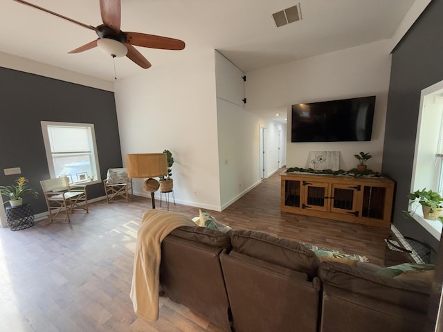 1581 W Lone Pine Dr, Baldwin, MI 49304 - living room featuring wood finished floors, a ceiling fan, and baseboards