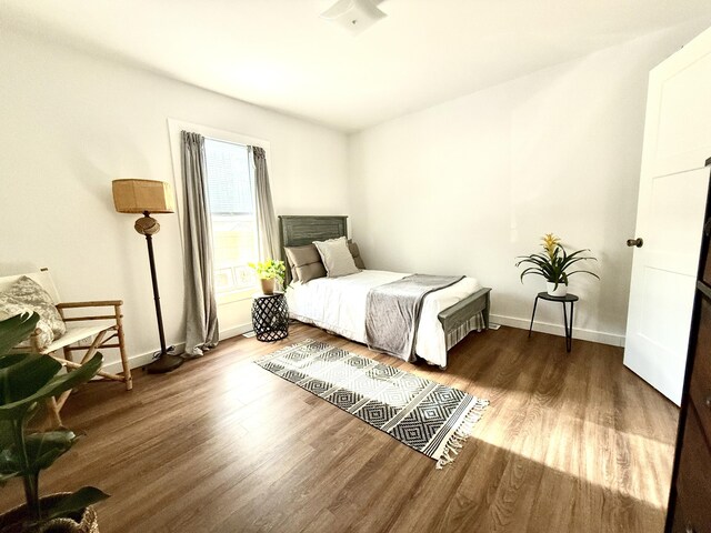 1581 W Lone Pine Dr, Baldwin, MI 49304 - bedroom featuring wood finished floors and baseboards