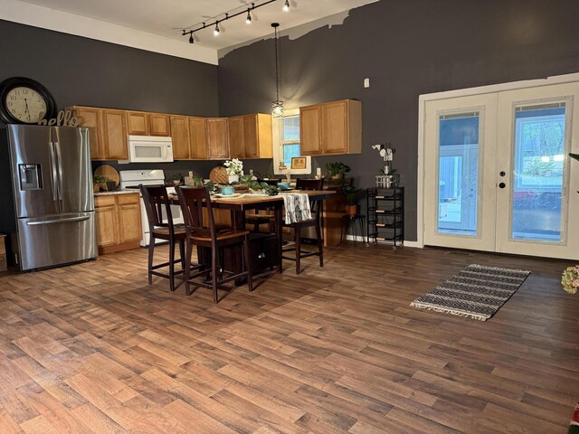 1581 W Lone Pine Dr, Baldwin, MI 49304 - kitchen with white appliances, a high ceiling, track lighting, french doors, and wood finished floors