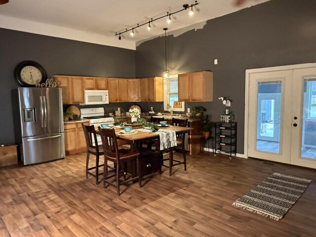 1581 W Lone Pine Dr, Baldwin, MI 49304 - kitchen with white appliances, a towering ceiling, rail lighting, french doors, and wood finished floors