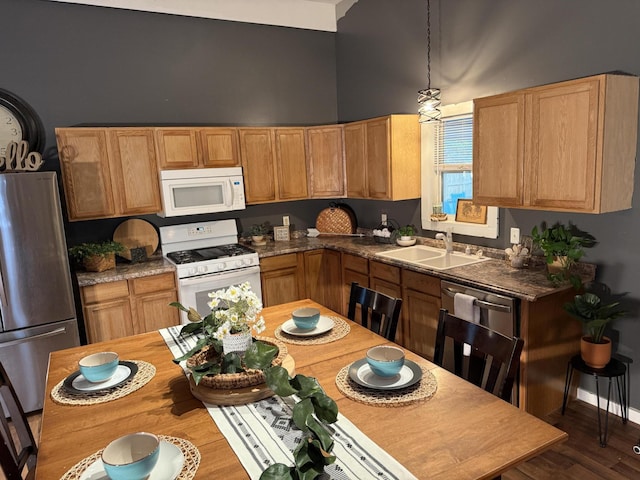 1581 W Lone Pine Dr, Baldwin, MI 49304 - kitchen featuring appliances with stainless steel finishes, a sink, a high ceiling, and dark wood-style floors
