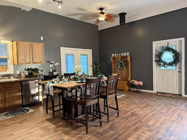 1581 W Lone Pine Dr, Baldwin, MI 49304 - dining room featuring high vaulted ceiling, a ceiling fan, wood finished floors, rail lighting, and baseboards