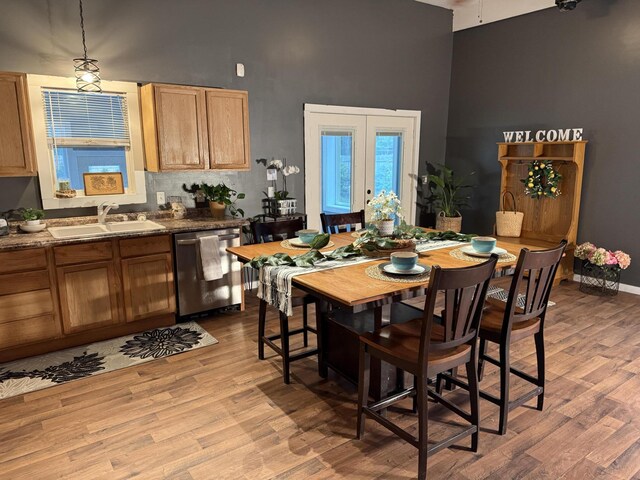 1581 W Lone Pine Dr, Baldwin, MI 49304 - dining area with a towering ceiling, wood finished floors, and baseboards